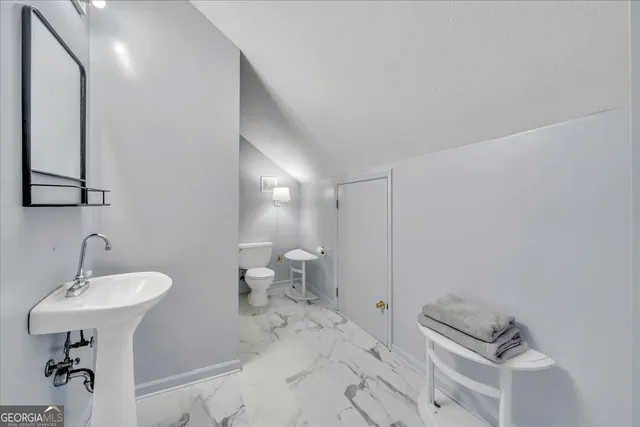 swimming pool view with a seating space and a garden