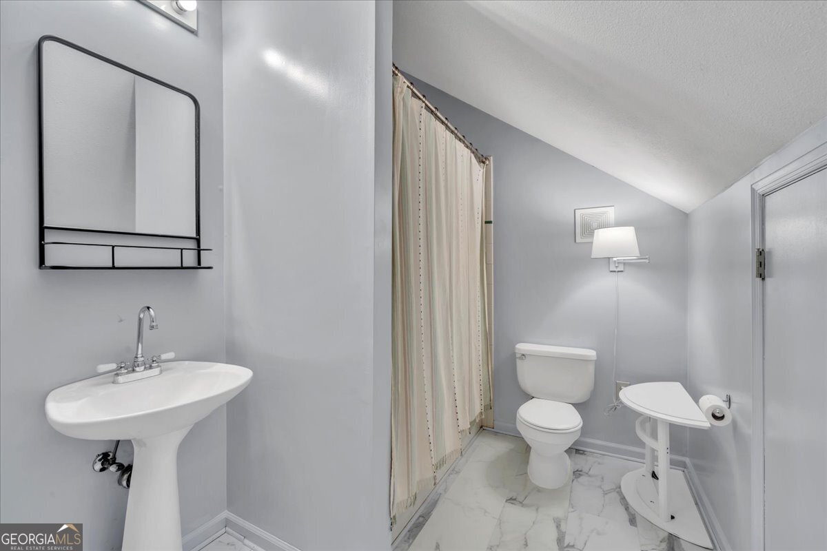 712 Stonewall Street Dublin, GA 31021 - Photo 48 of 65 a bathroom with a sink toilet and shower