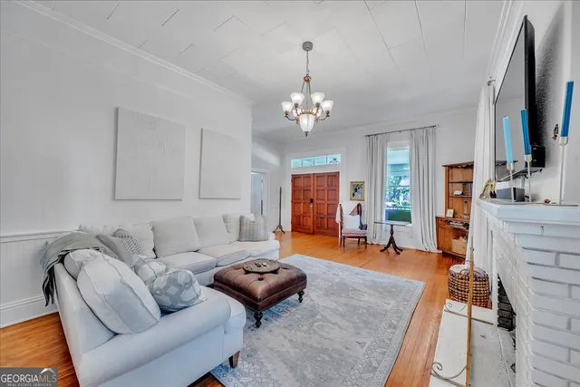 a living room with furniture flat screen tv and a fireplace