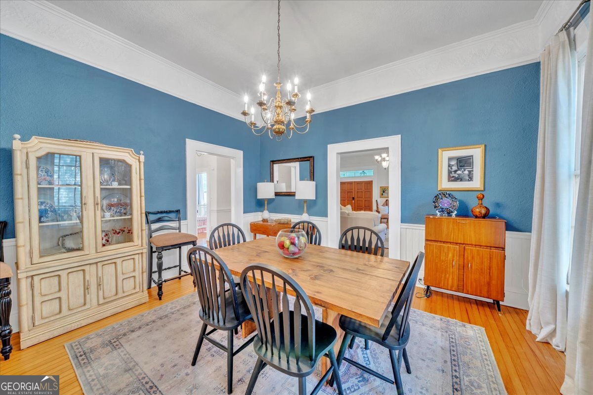 712 Stonewall Street Dublin, GA 31021 - Photo 10 of 65 a dining room with furniture a livingroom with furniture wooden floor a rug and a chandelier