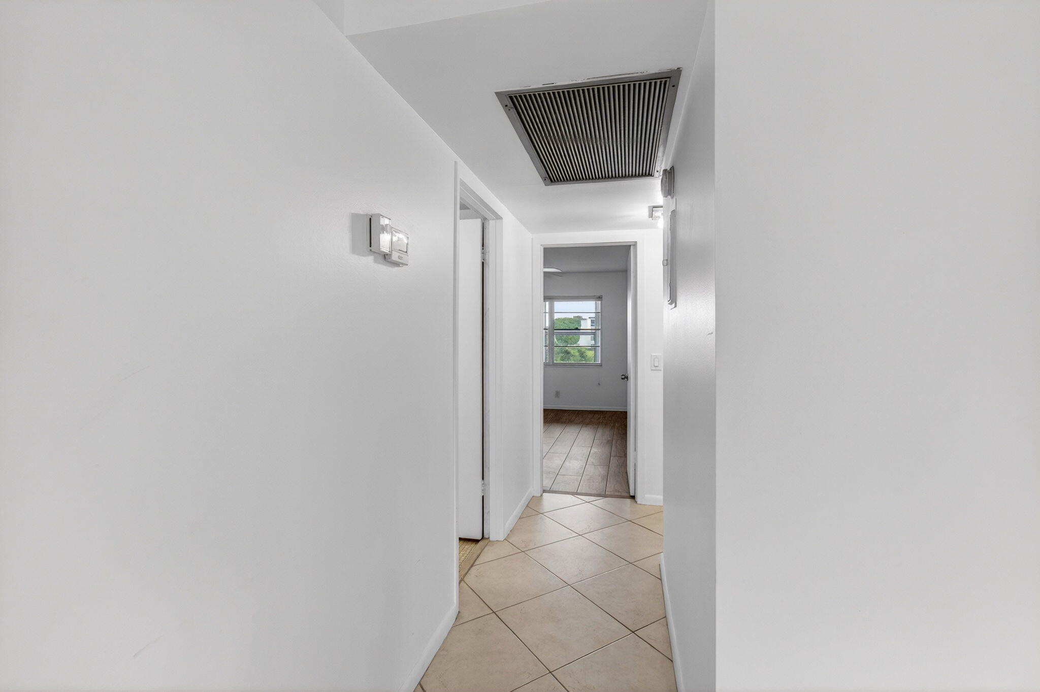 2027 Exeter Boca Raton, FL 33434 - Photo 30 of 100 a view of a hallway with wooden floor and a bathroom
