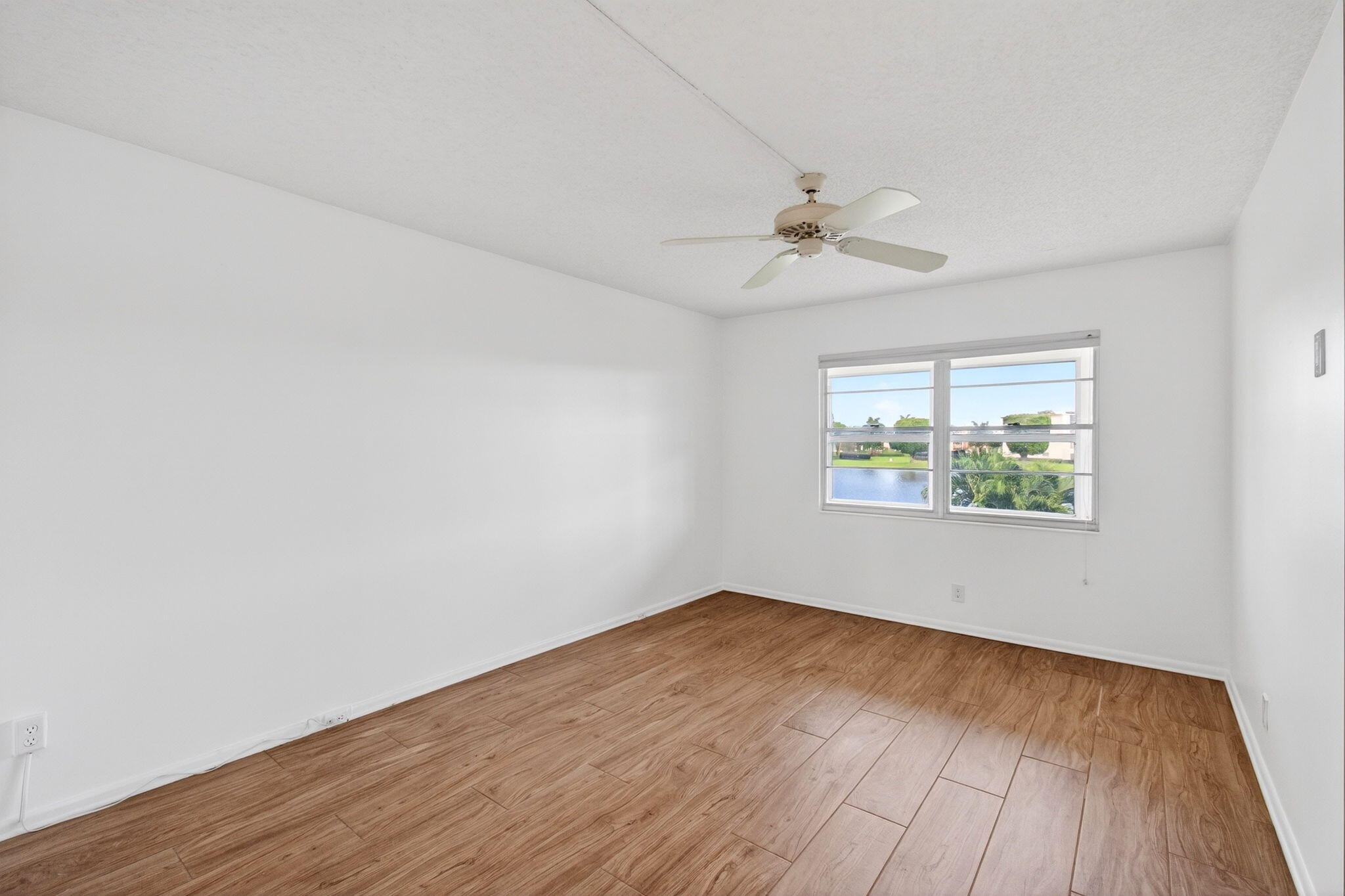 2027 Exeter Boca Raton, FL 33434 - Photo 32 of 100 an empty room with wooden floor and windows