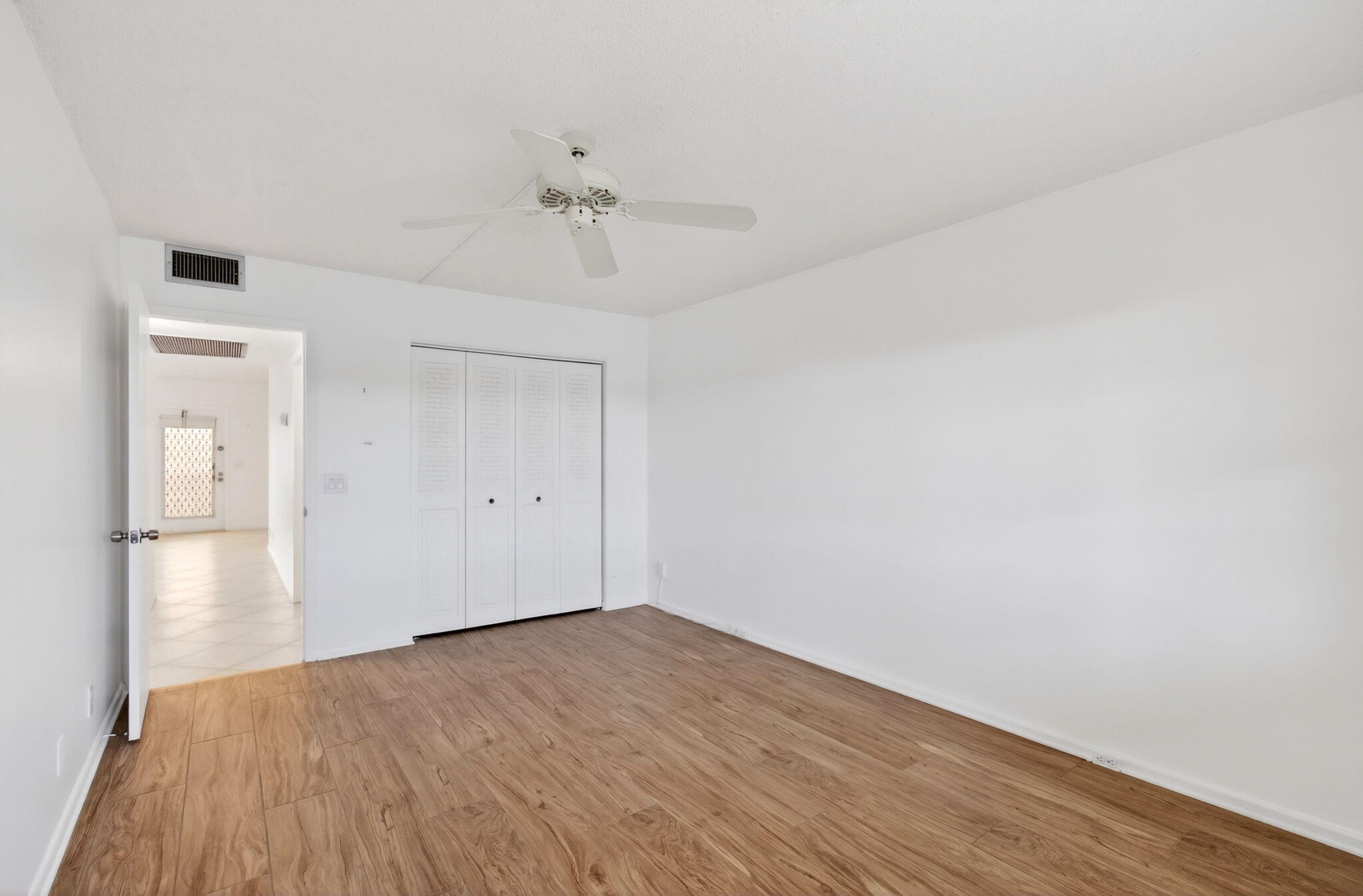 2027 Exeter Boca Raton, FL 33434 - Photo 33 of 100 a view of empty room with wooden floor and fan