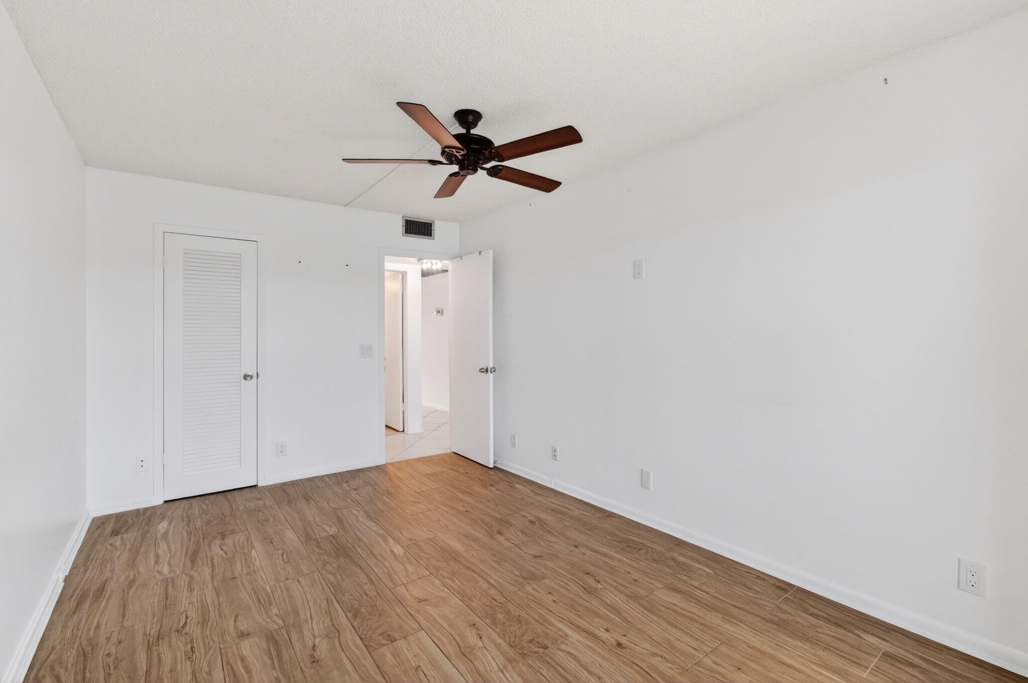 2027 Exeter Boca Raton, FL 33434 - Photo 41 of 100 a view of empty room with wooden floor