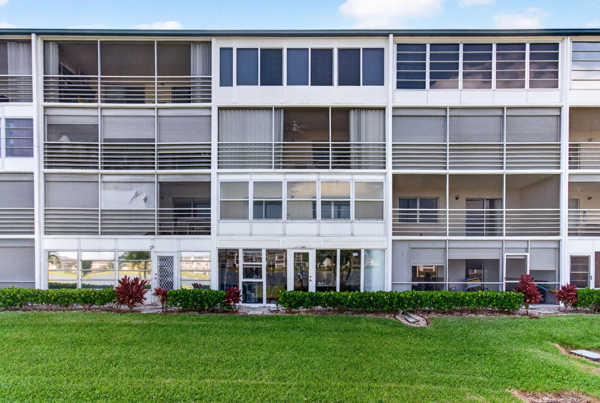 2027 Exeter Boca Raton, FL 33434 - Photo 55 of 100 a large building with a garden view