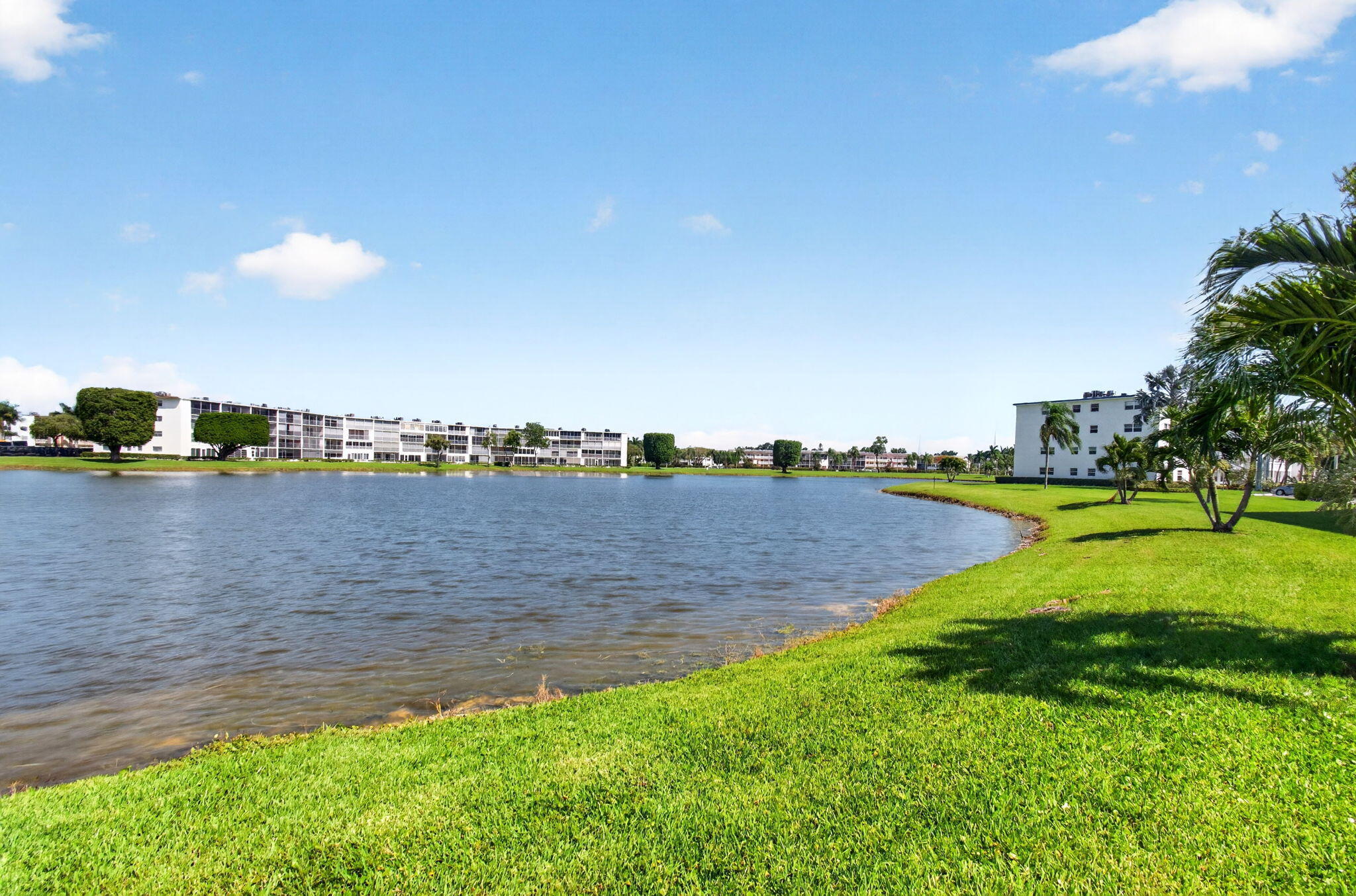 2027 Exeter Boca Raton, FL 33434 - Photo 57 of 100 a view of a lake with houses in the back