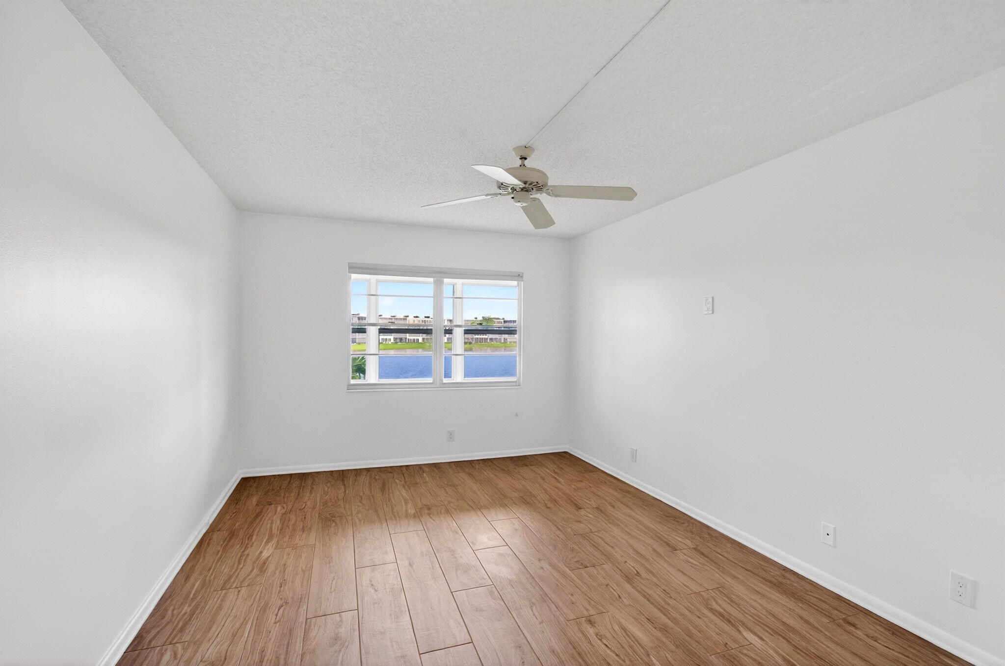 2027 Exeter Boca Raton, FL 33434 - Photo 8 of 100 wooden floor in an empty room with a window