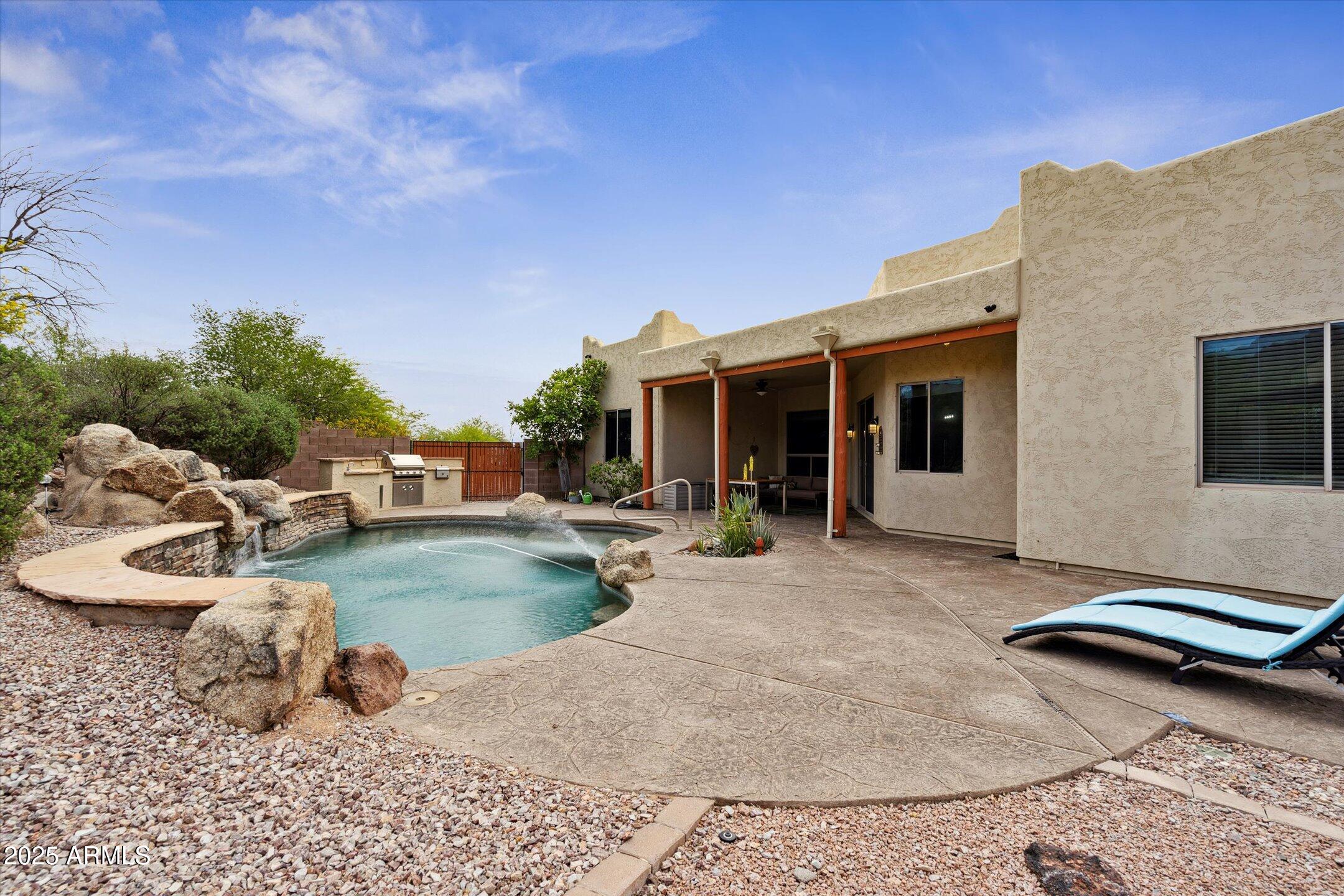 5772 East 1st Avenue Apache Junction, AZ 85119 - Photo 55 of 57 a backyard of a house with table and chairs
