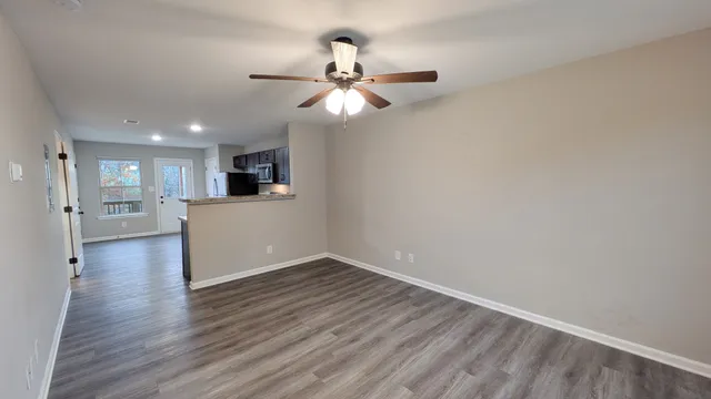 a view of a kitchen with wooden floor and a kitchen