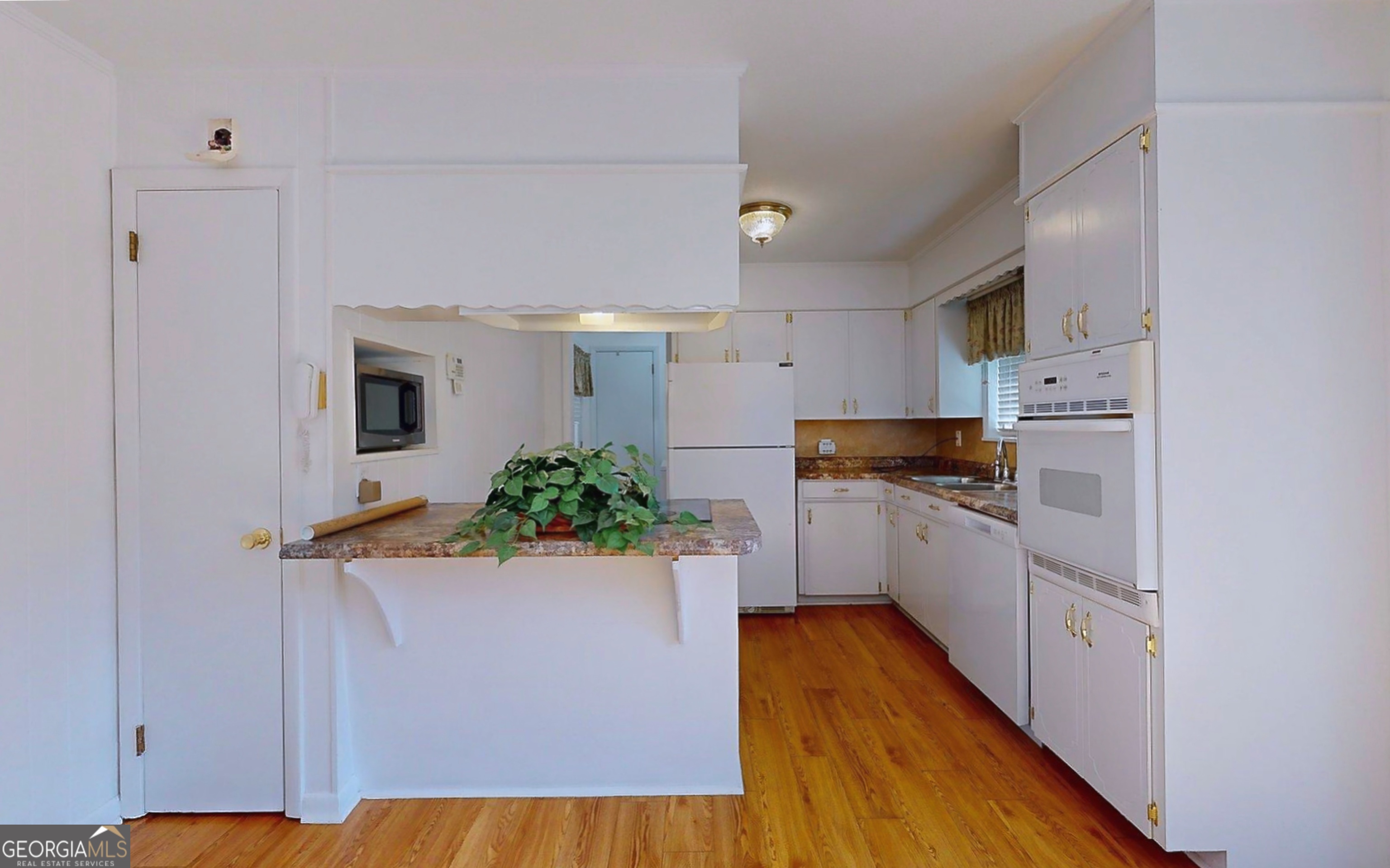 104 Azalea Lane Reidsville, GA 30453 - Photo 20 of 50 a kitchen with cabinets and wooden floor