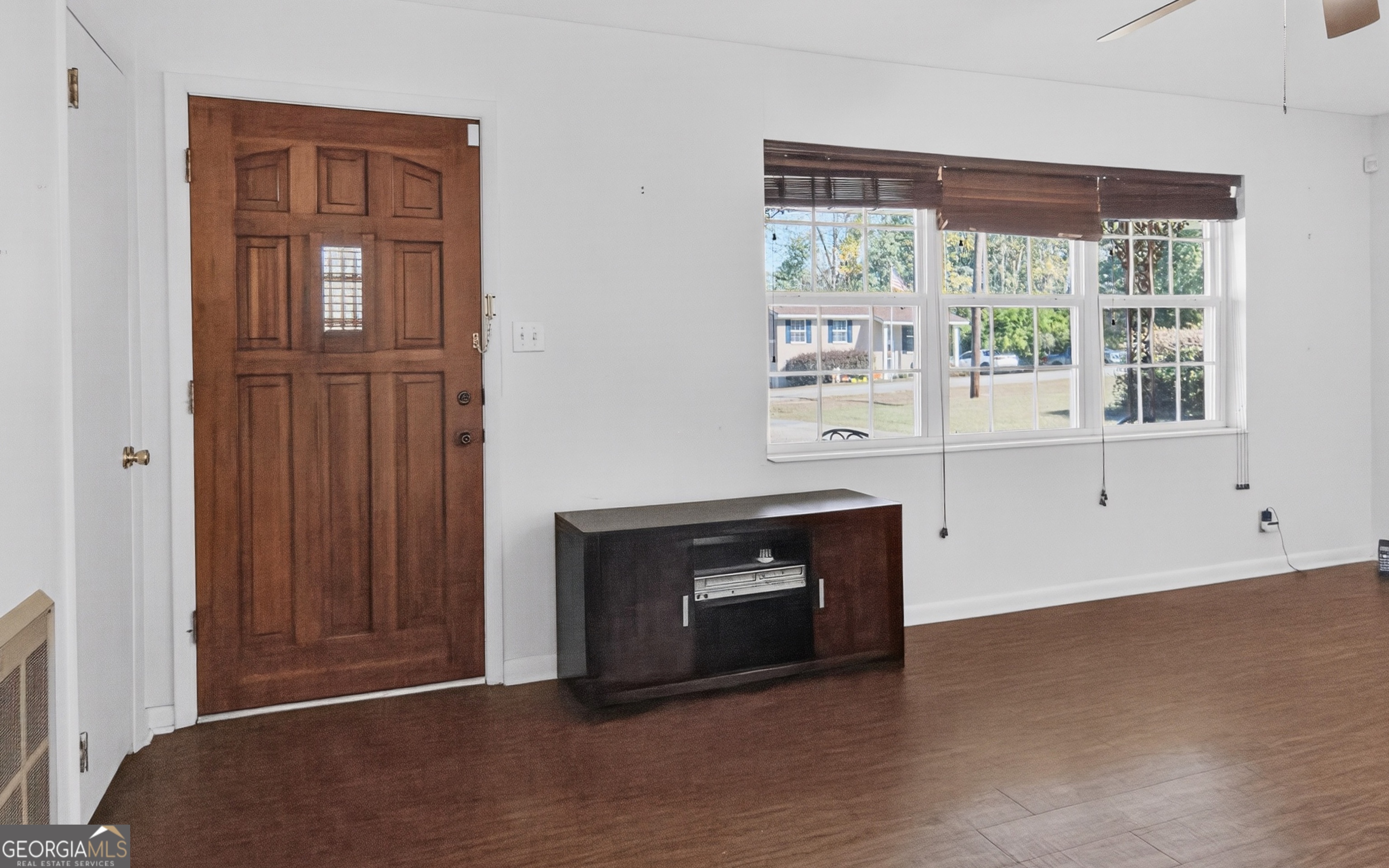 104 Azalea Lane Reidsville, GA 30453 - Photo 24 of 50 a room with wooden floor and a fireplace