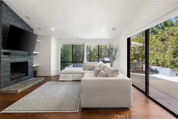 a living room with furniture a flat screen tv and a fireplace