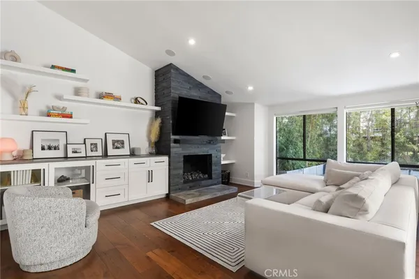 a living room with furniture fireplace and flat screen tv