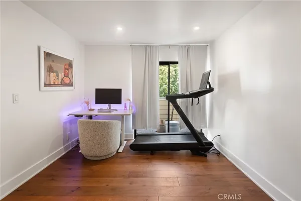 a view of room with hardwood floor and closet