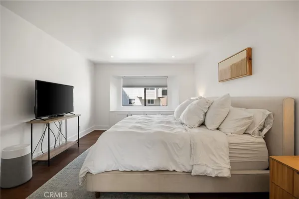 a bedroom with a bed and a night stand