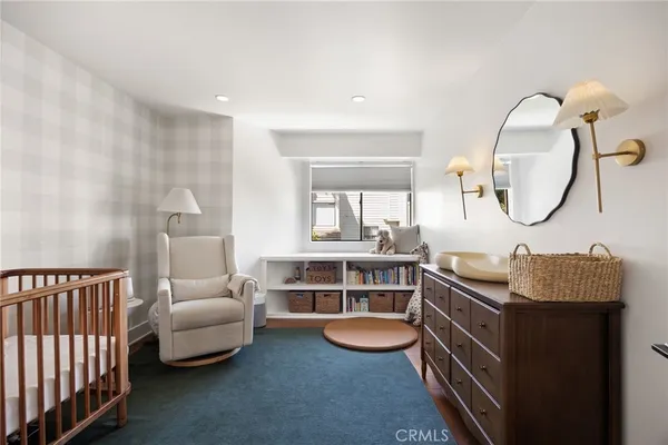 a bedroom with furniture and a window