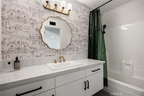 a bathroom with sink mirror and vanity