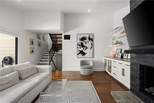 a living room with furniture a rug and a flat screen tv