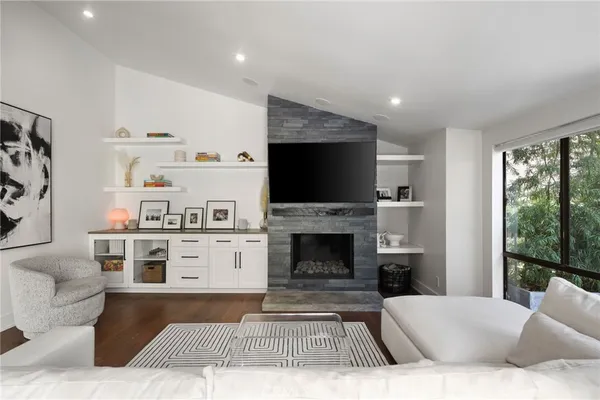 a living room with furniture and a fireplace