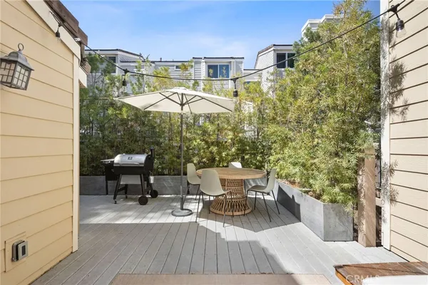 a view of balcony with wooden floor and outdoor seating