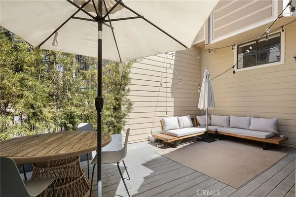 a balcony with furniture and a potted plant
