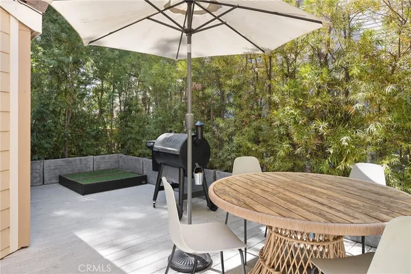 a living room with furniture a flat screen tv and a chandelier