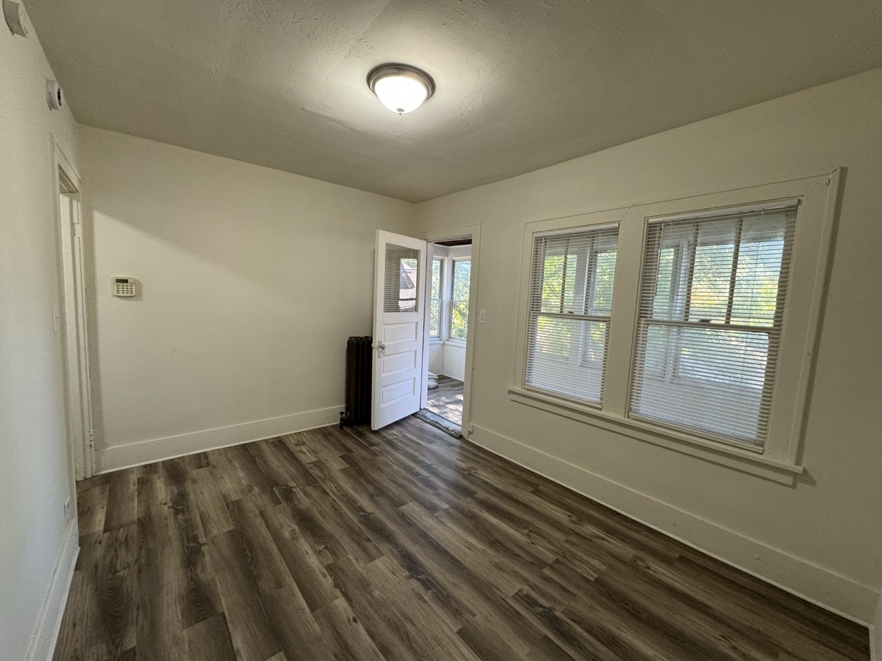 159 North 4th Street, Unit 3 Aurora, IL 60505 - Photo 4 of 12 an empty room with wooden floor and windows