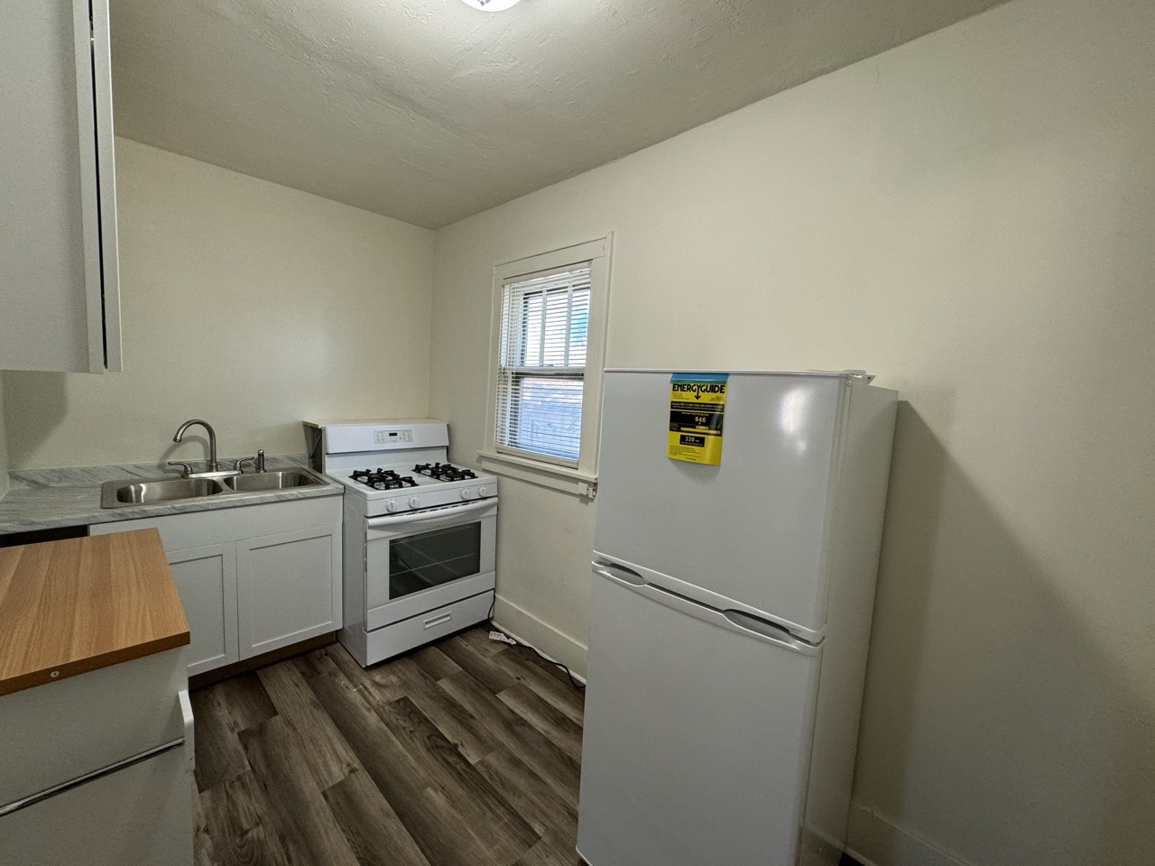 159 North 4th Street, Unit 3 Aurora, IL 60505 - Photo 6 of 12 a white refrigerator freezer sitting inside of a kitchen