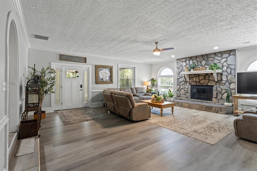 564 Eskew Road McDonough, GA 30252 - Photo 12 of 54 a living room with furniture a fireplace and a flat screen tv