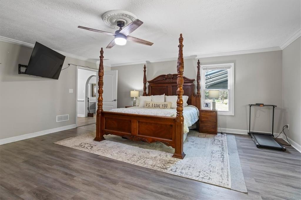 564 Eskew Road McDonough, GA 30252 - Photo 16 of 54 a bedroom with a bed window and a flat screen tv