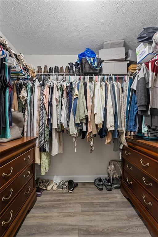 564 Eskew Road McDonough, GA 30252 - Photo 18 of 54 a view of walk in closet with clothes and shoes