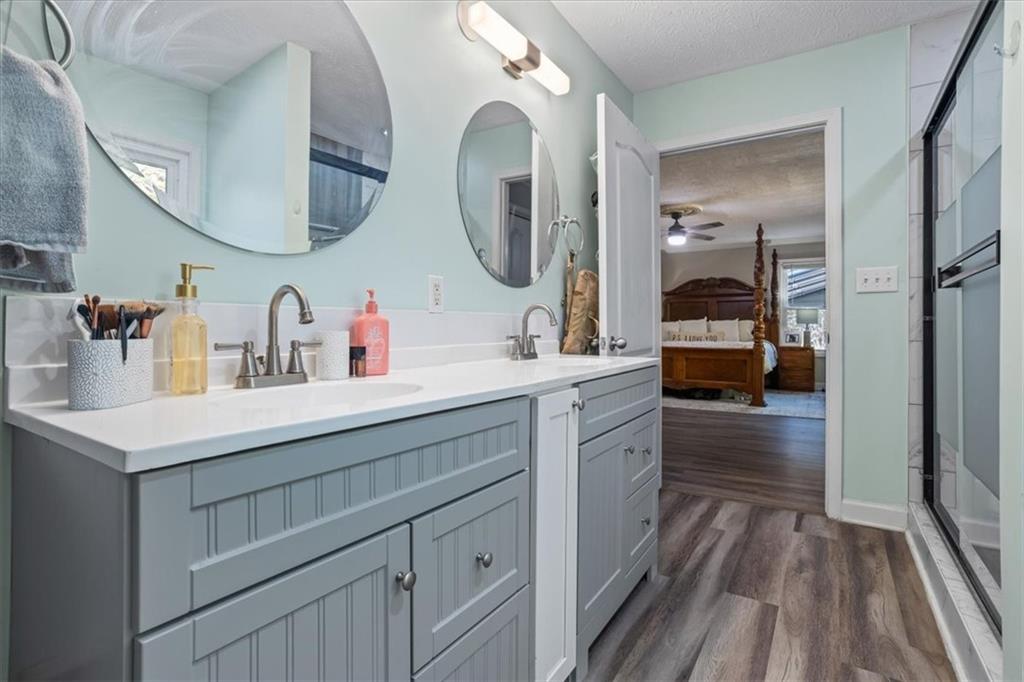 564 Eskew Road McDonough, GA 30252 - Photo 20 of 54 a en suite bathroom with a double vanity sink and a mirror