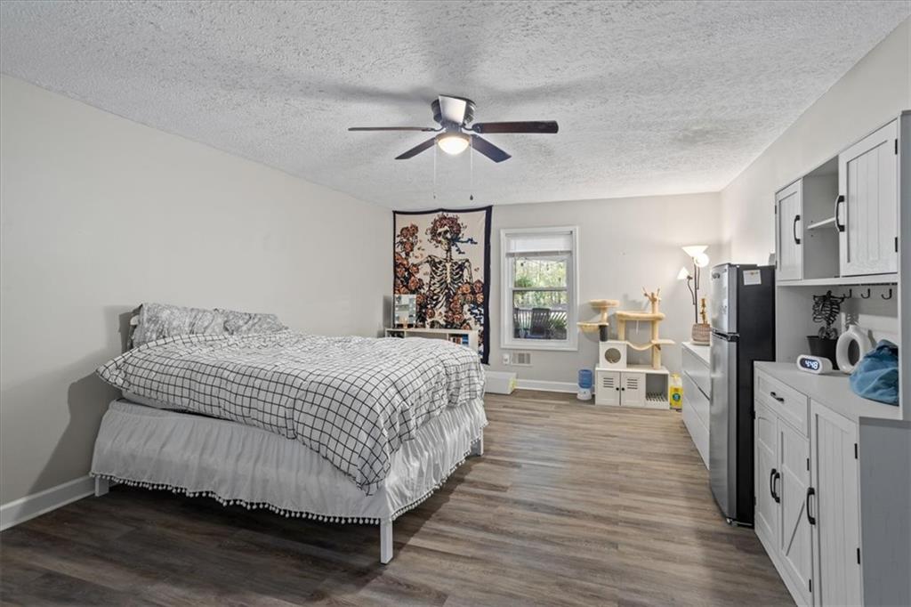 564 Eskew Road McDonough, GA 30252 - Photo 21 of 54 a spacious bedroom with a bed and a walk in closet