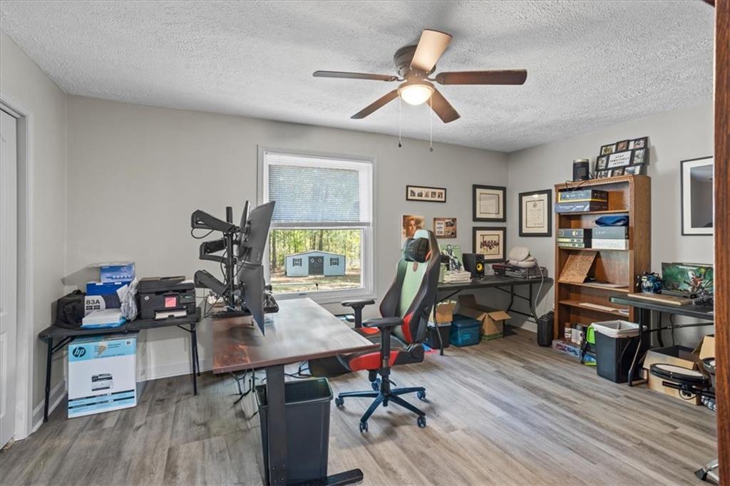 564 Eskew Road McDonough, GA 30252 - Photo 23 of 54 a view of a workspace with furniture and wooden floor
