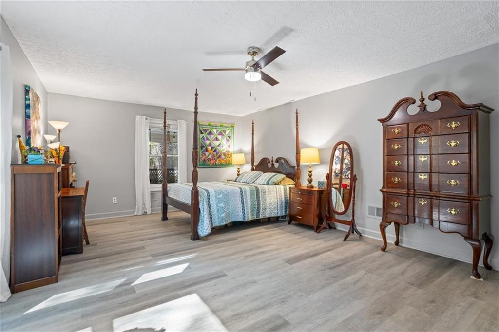564 Eskew Road McDonough, GA 30252 - Photo 25 of 54 a bedroom with furniture and a wooden floor