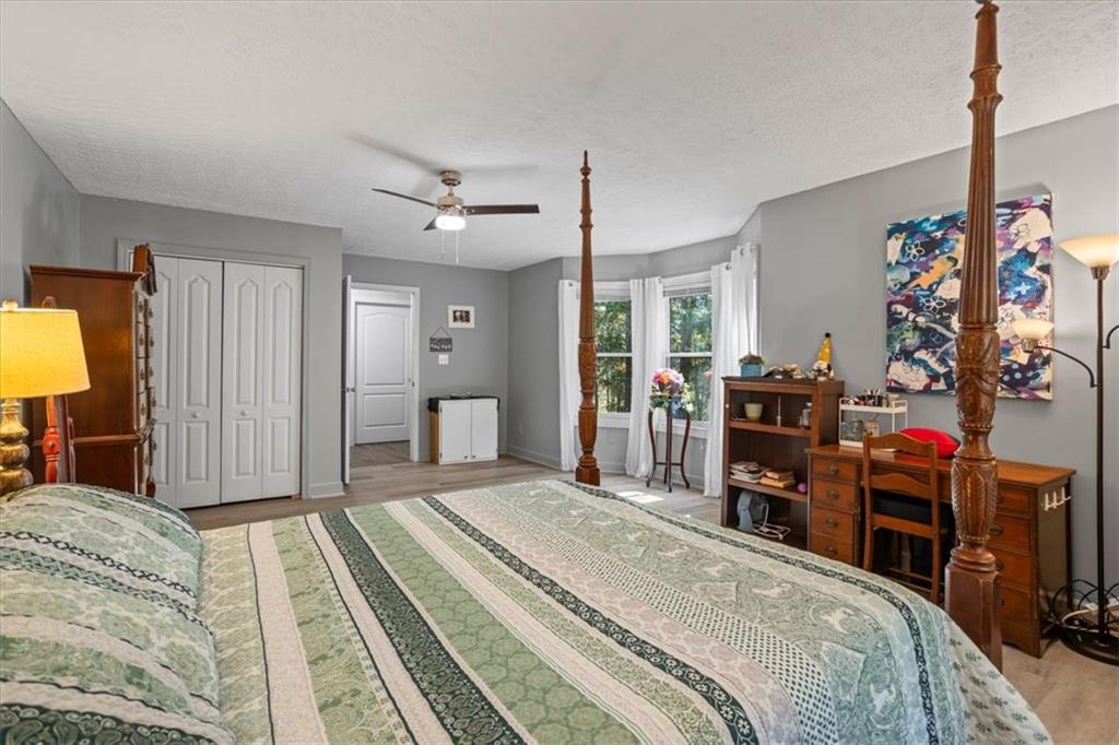 564 Eskew Road McDonough, GA 30252 - Photo 27 of 54 a bedroom with a bed and a flat tv screen