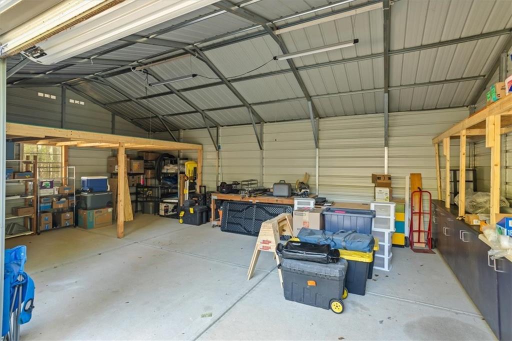 564 Eskew Road McDonough, GA 30252 - Photo 44 of 54 a view of a patio with table and chairs and a barbeque