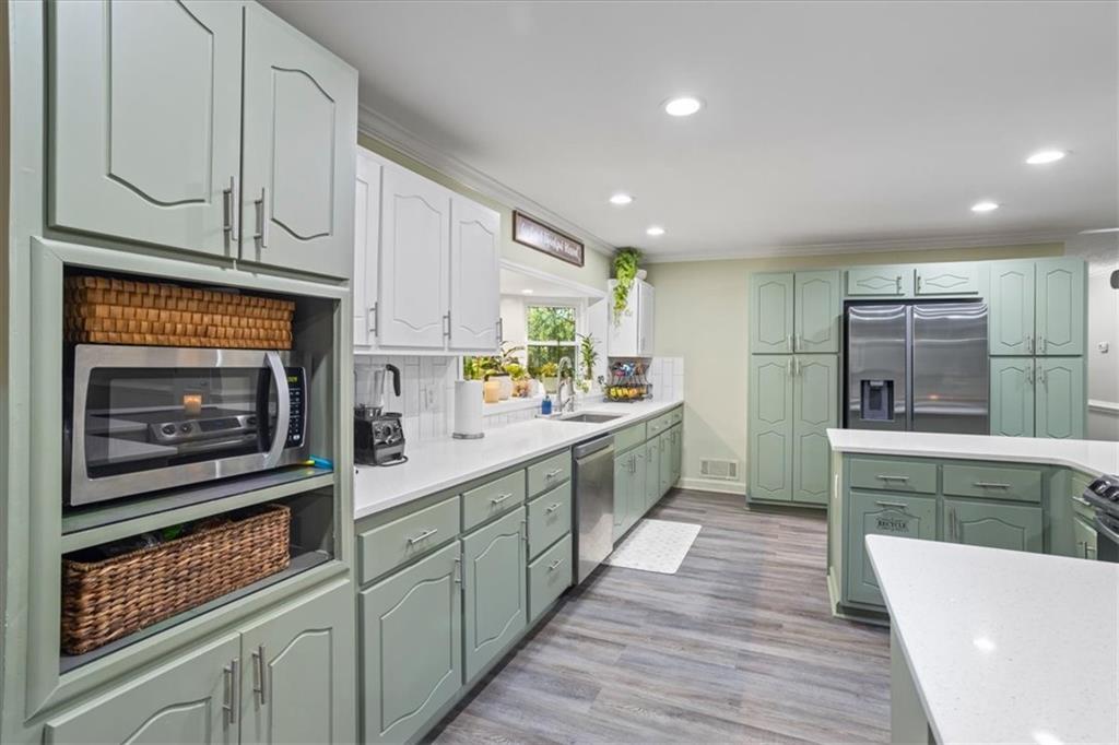 564 Eskew Road McDonough, GA 30252 - Photo 7 of 54 a kitchen with counter top space and stainless steel appliances