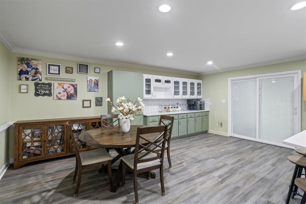 564 Eskew Road McDonough, GA 30252 - Photo 10 of 54 a view of a dining room with furniture and wooden floor