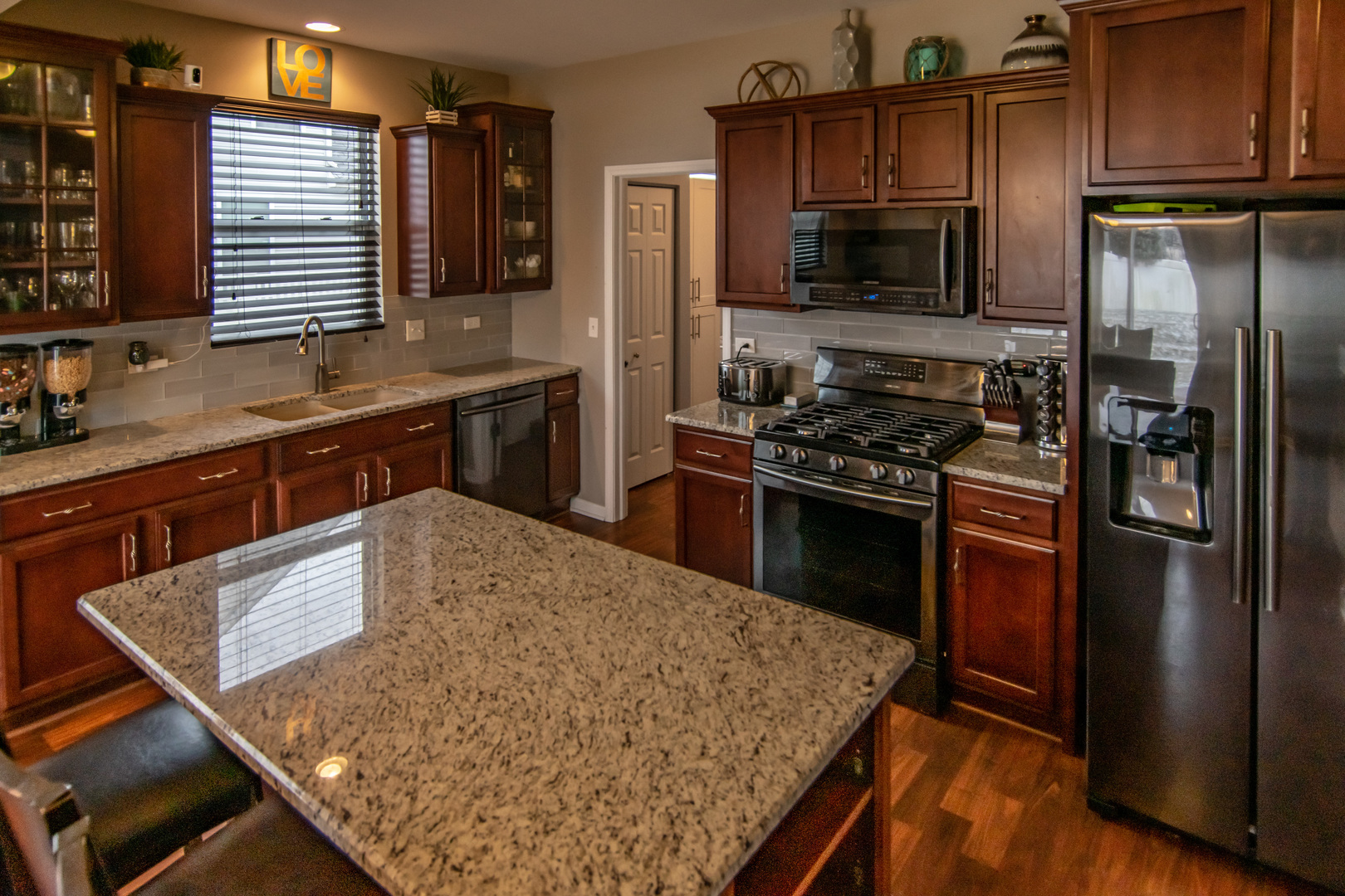 6500 Roth Drive Joliet, IL 60431 - Photo 17 of 36 a kitchen with stainless steel appliances granite countertop a refrigerator a stove and a sink