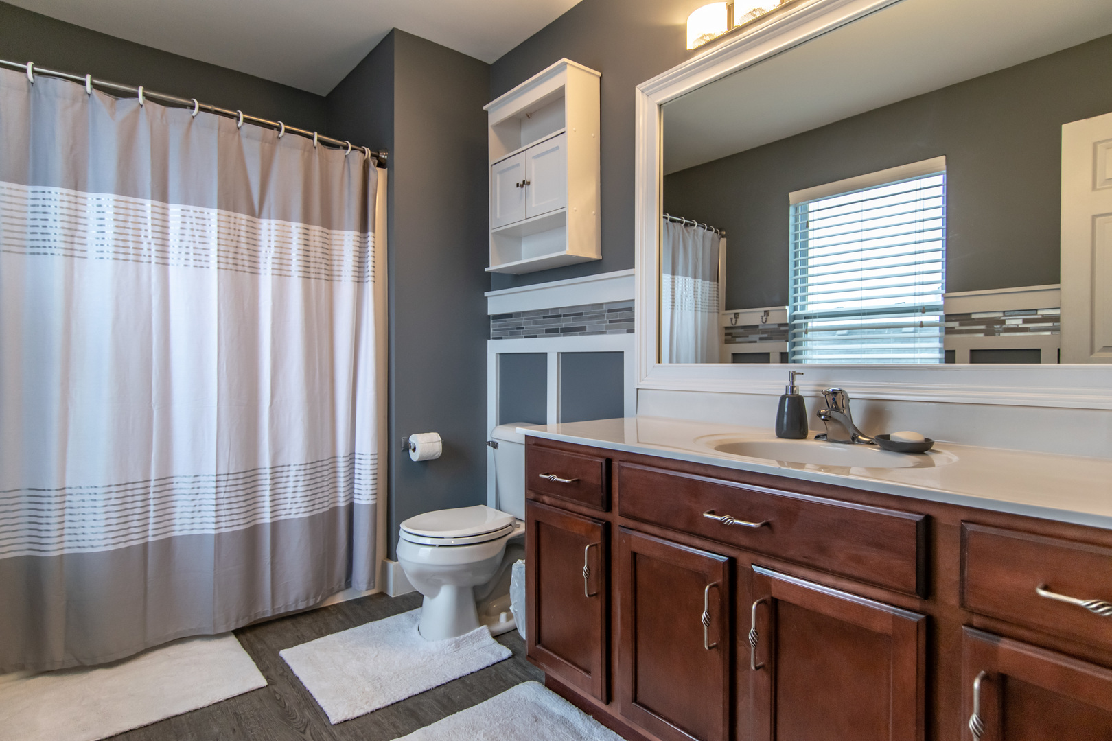 6500 Roth Drive Joliet, IL 60431 - Photo 29 of 36 a bathroom with a sink a toilet a mirror and shower curtain