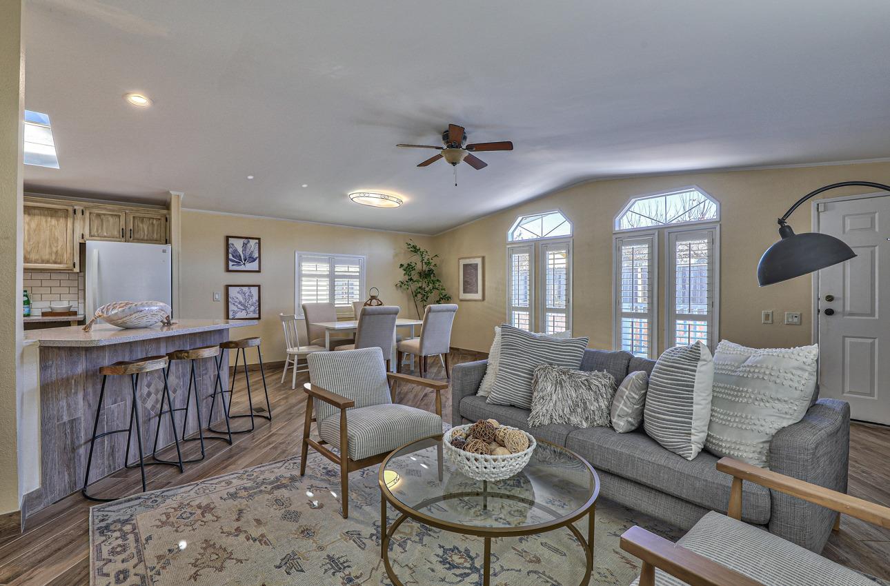 20 Russell Road, Unit 131 Salinas, CA 93906 - Photo 3 of 9 a living room with furniture a dining table and a fireplace