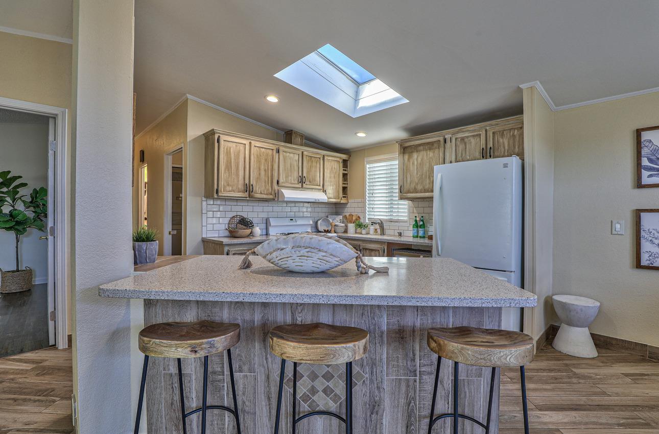 20 Russell Road, Unit 131 Salinas, CA 93906 - Photo 4 of 9 a kitchen with a table chairs and refrigerator