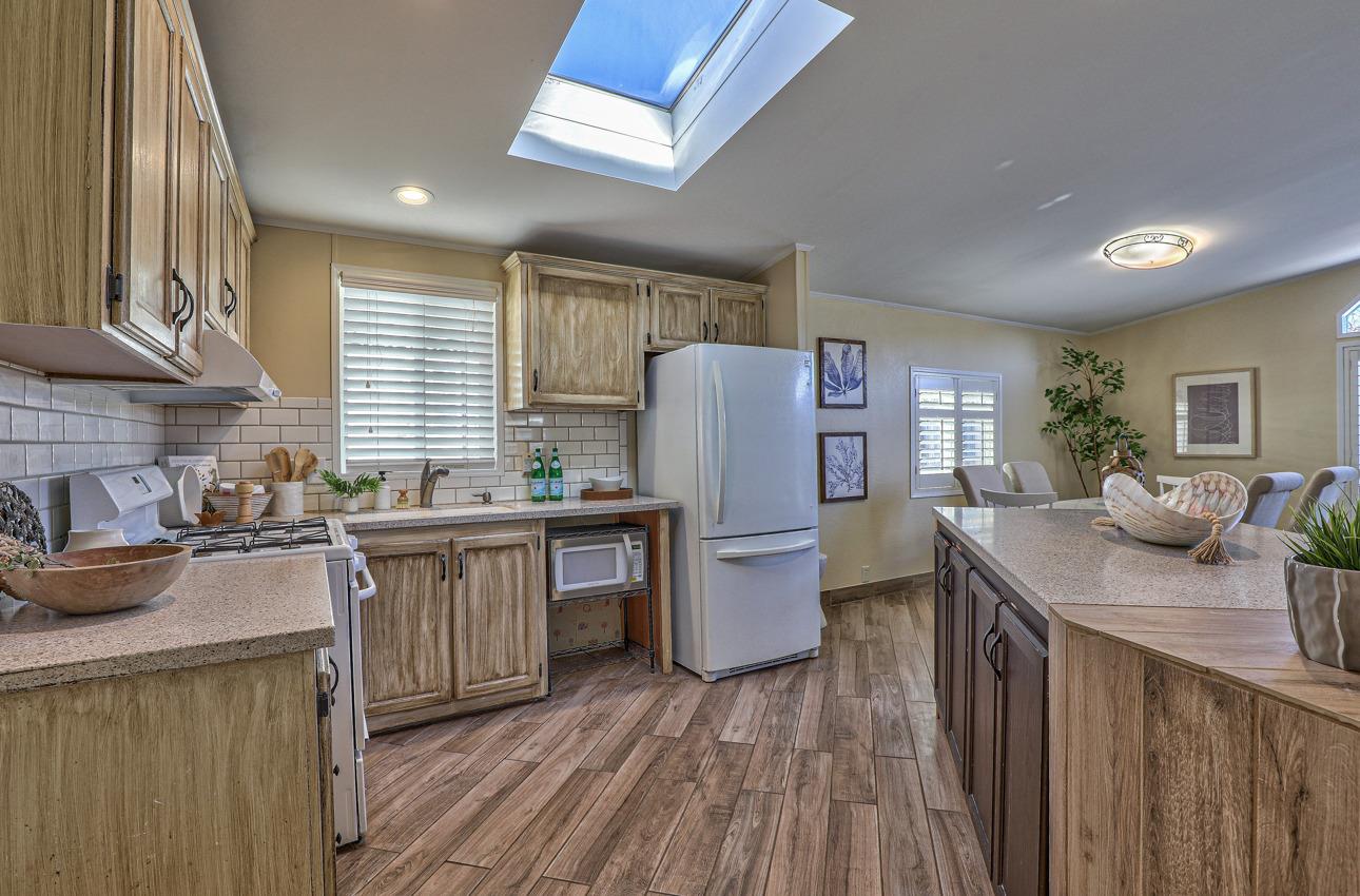 20 Russell Road, Unit 131 Salinas, CA 93906 - Photo 5 of 9 a kitchen with sink a refrigerator and cabinets
