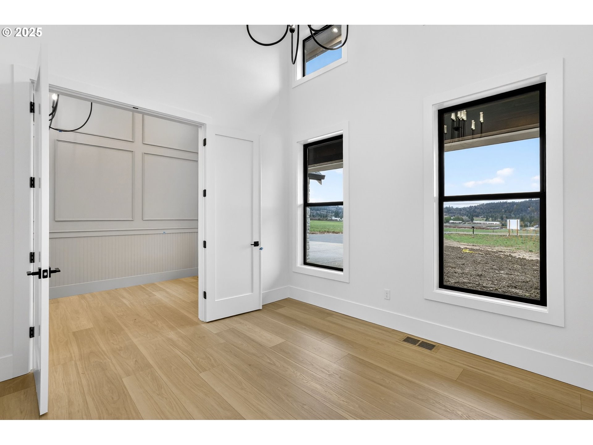 23322 Southeast Bohna Park Road Damascus, OR 97089 - Photo 31 of 40 a view of an empty room with closet and wooden floor