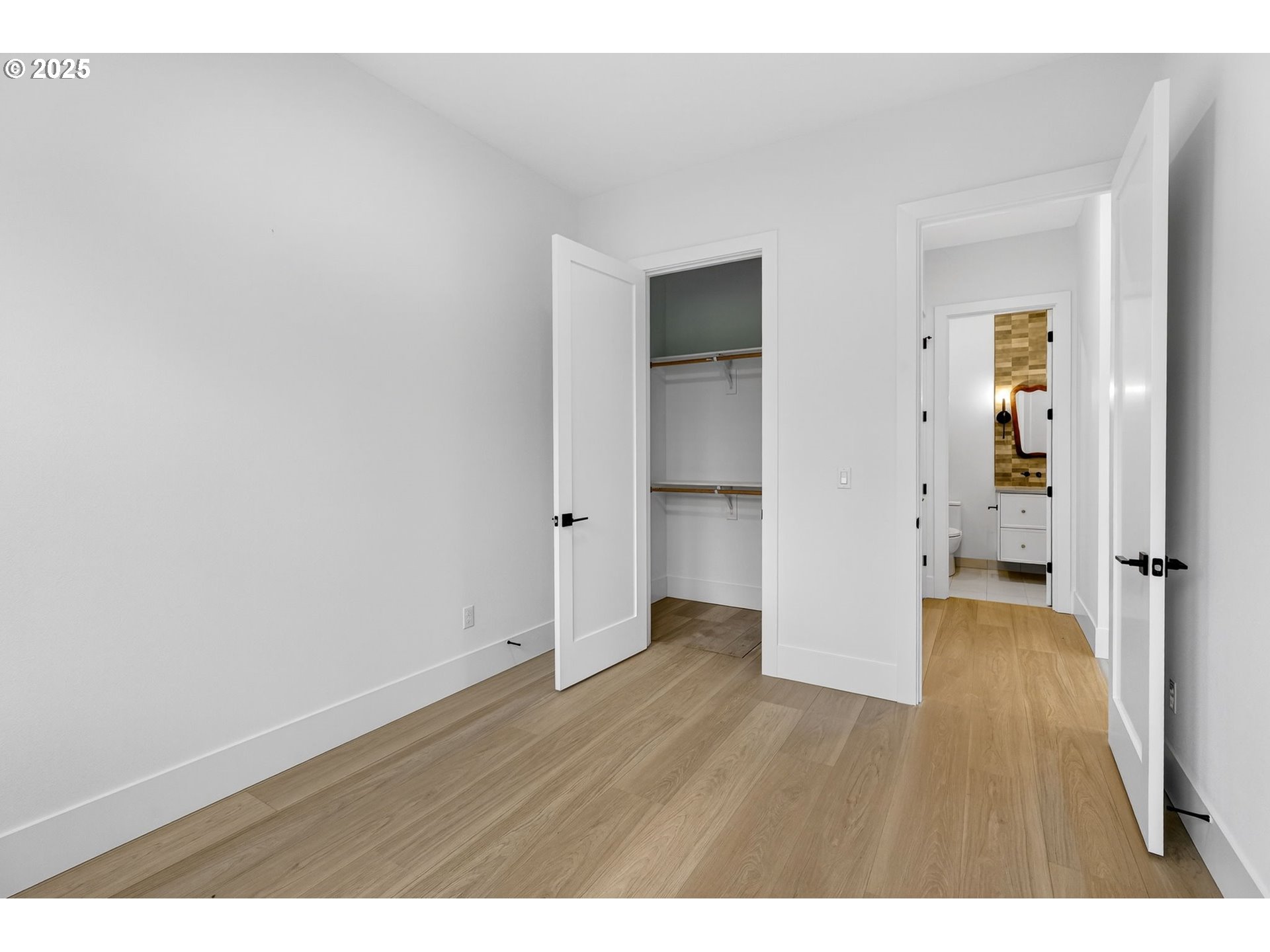 23322 Southeast Bohna Park Road Damascus, OR 97089 - Photo 37 of 40 a view of an empty room with wooden floor