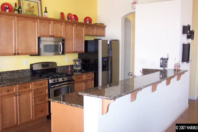 1605 Arboleda Drive Reno, NV 89521 - Photo 4 of 9 a kitchen with stainless steel appliances granite countertop a sink stove and refrigerator