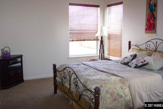 1605 Arboleda Drive Reno, NV 89521 - Photo 7 of 9 a bedroom with a bed and two windows