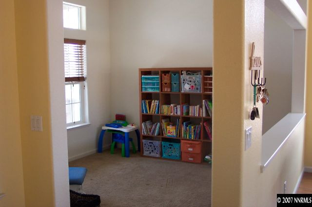 1605 Arboleda Drive Reno, NV 89521 - Photo 9 of 9 a view of an empty room with shelves and wooden floor