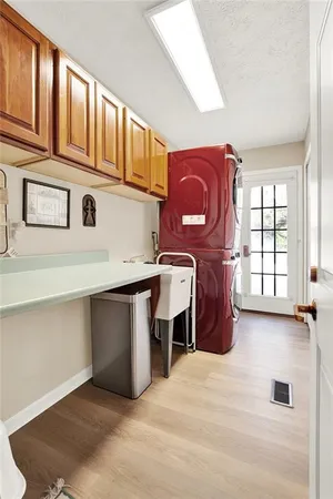 a bedroom with a bed and a lamp on dresser